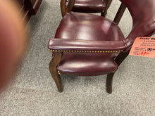 Load image into Gallery viewer, Side view of burgundy guest chair arm with nailhead trim