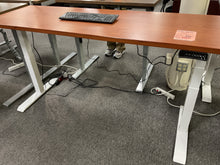 Load image into Gallery viewer, Used electric standing desk with cherry laminate top and white frame